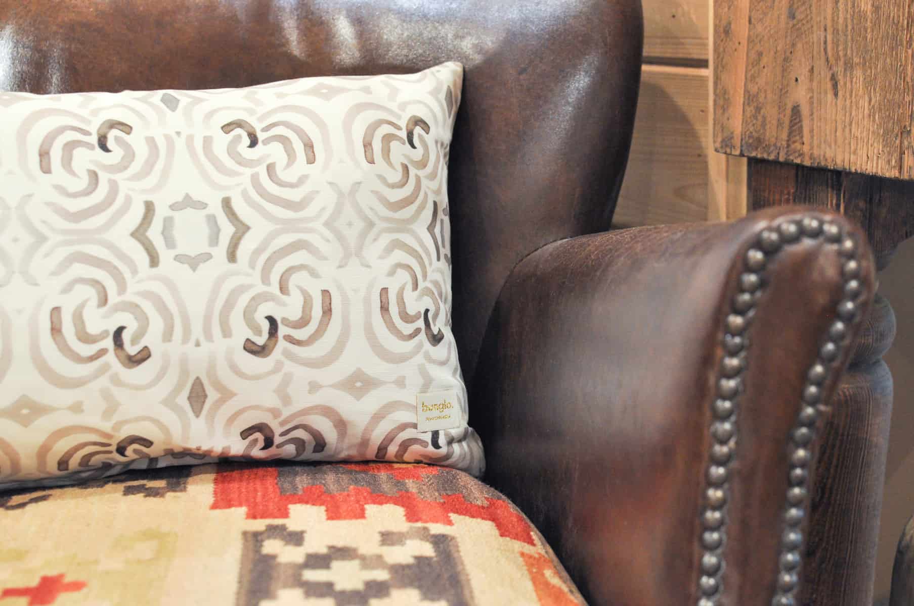 Home Furnishings: Leather chair with reversible cushion and bunglo accent pillow.